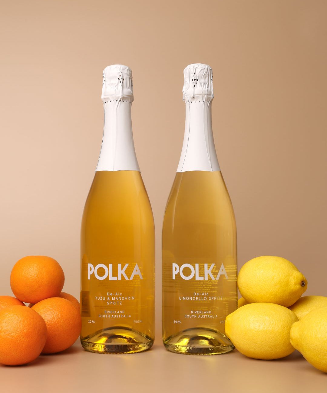 polka non alcoholic yuzu mandarin spritz and limoncello spritz on plain background 