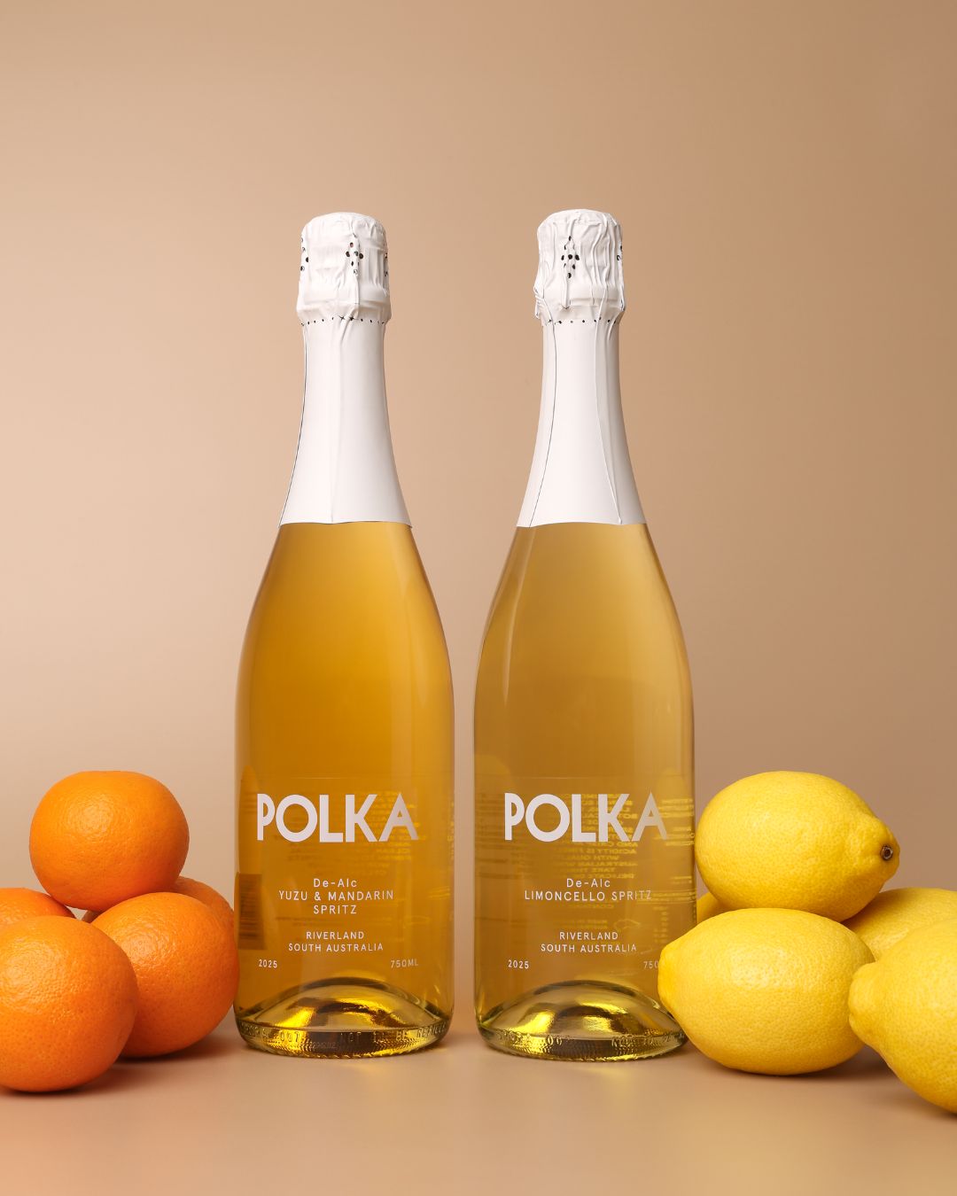polka non alcoholic yuzu mandarin spritz and limoncello spritz on plain background 