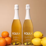 polka non alcoholic yuzu mandarin spritz and limoncello spritz on plain background 