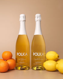 polka non alcoholic yuzu mandarin spritz and limoncello spritz on plain background 