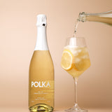 polka non alcoholic limoncello spritz pouring into glass on plain background